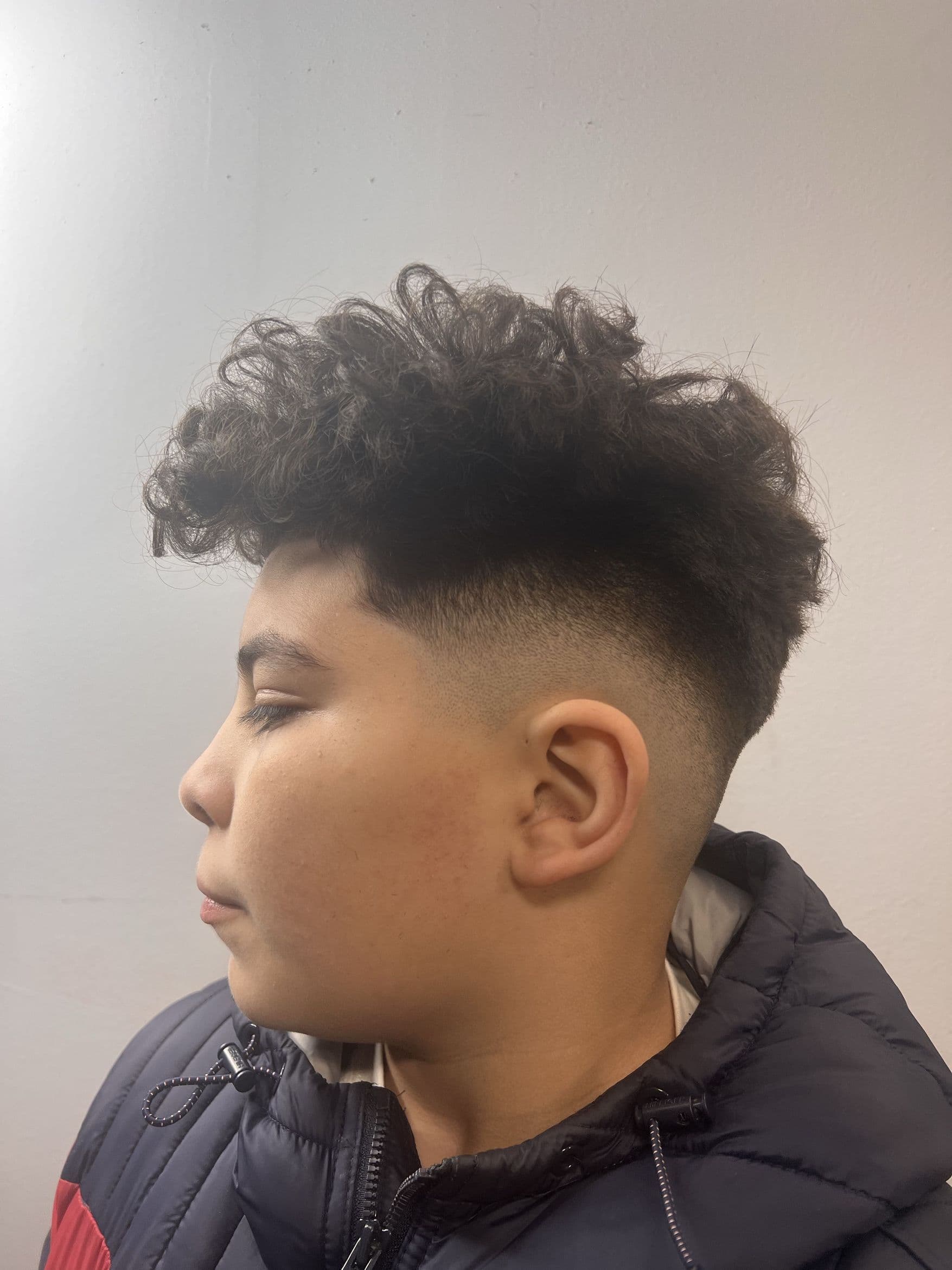 Curly fade haircut by LooksBySerge from Booksy portfolio