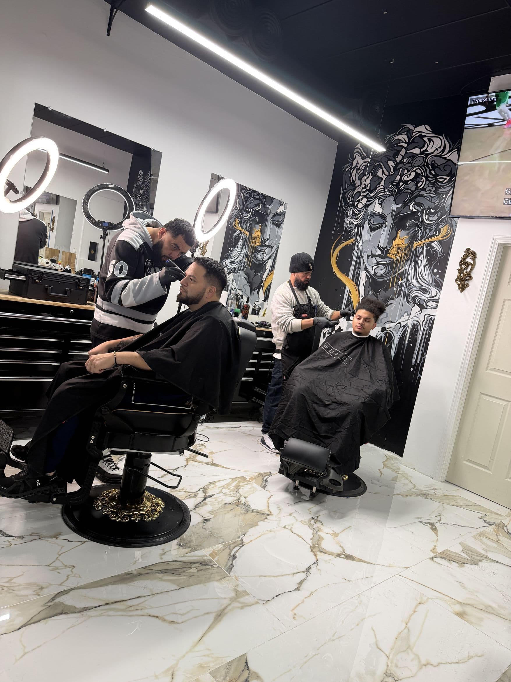 Barbers working inside Aces Barbershop in North Providence, Rhode Island
