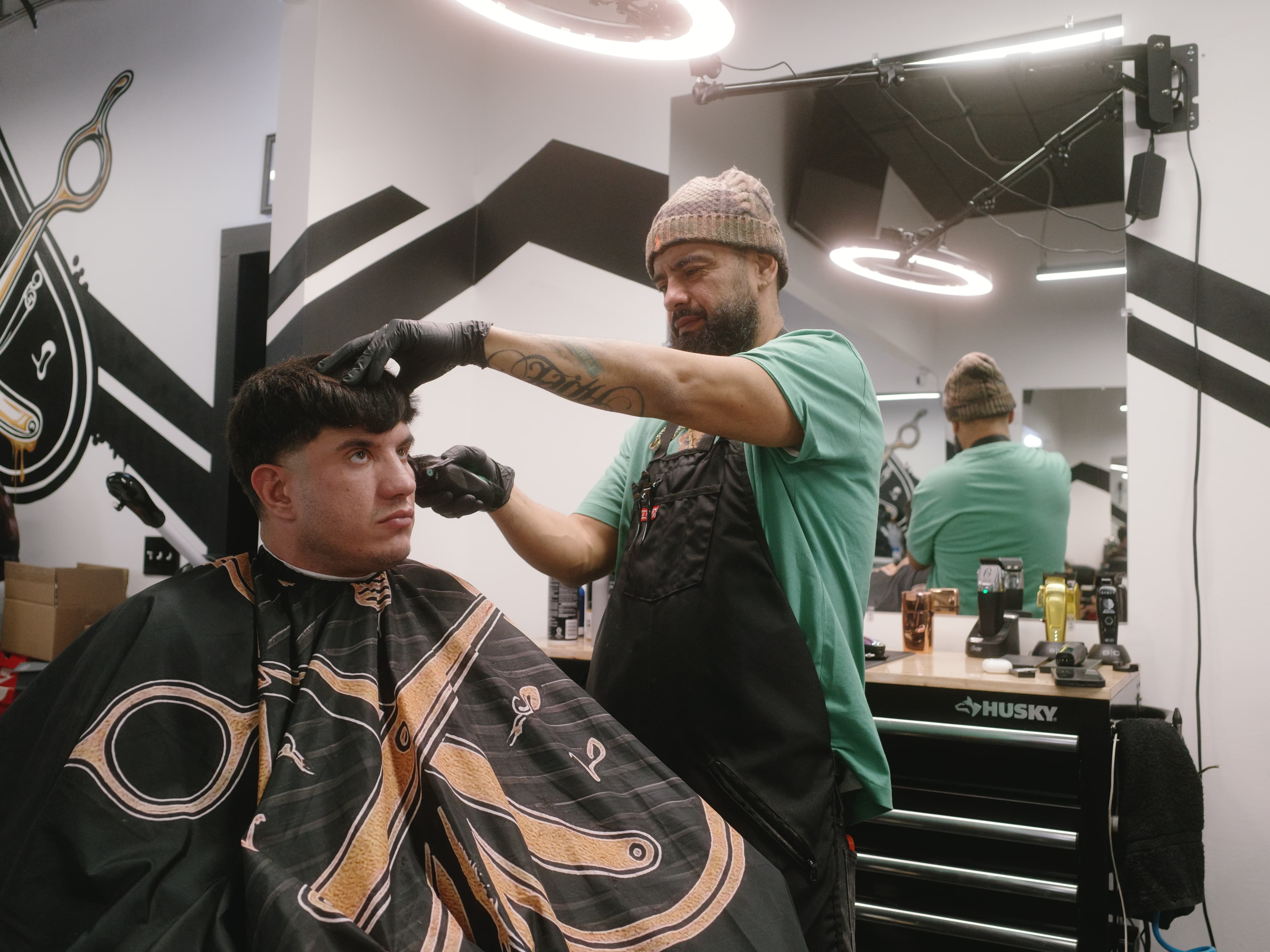 Haircut in progress at an Aces Barbershop station