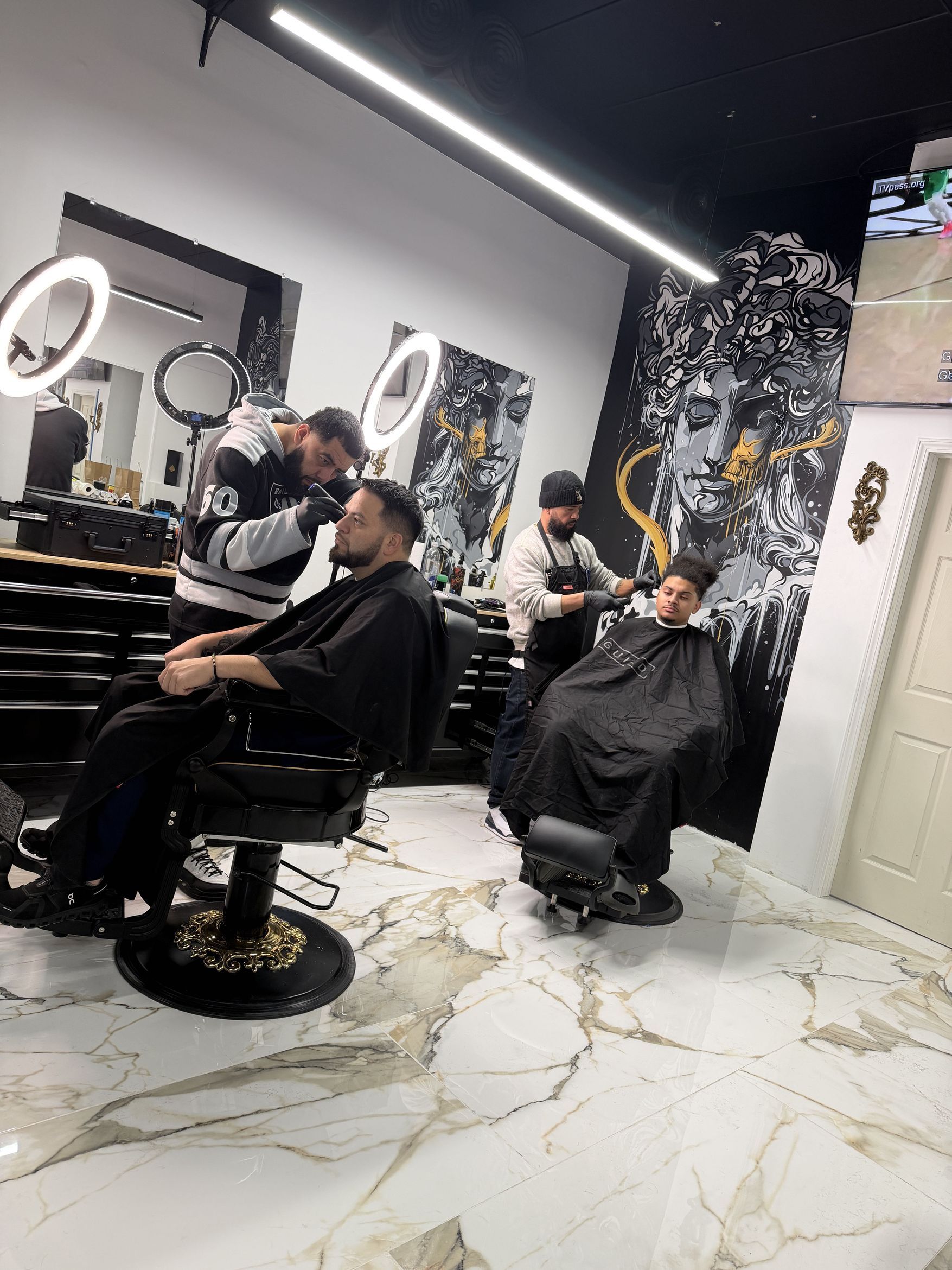 Barbers working inside Ace’s Barbershop in North Providence, Rhode Island